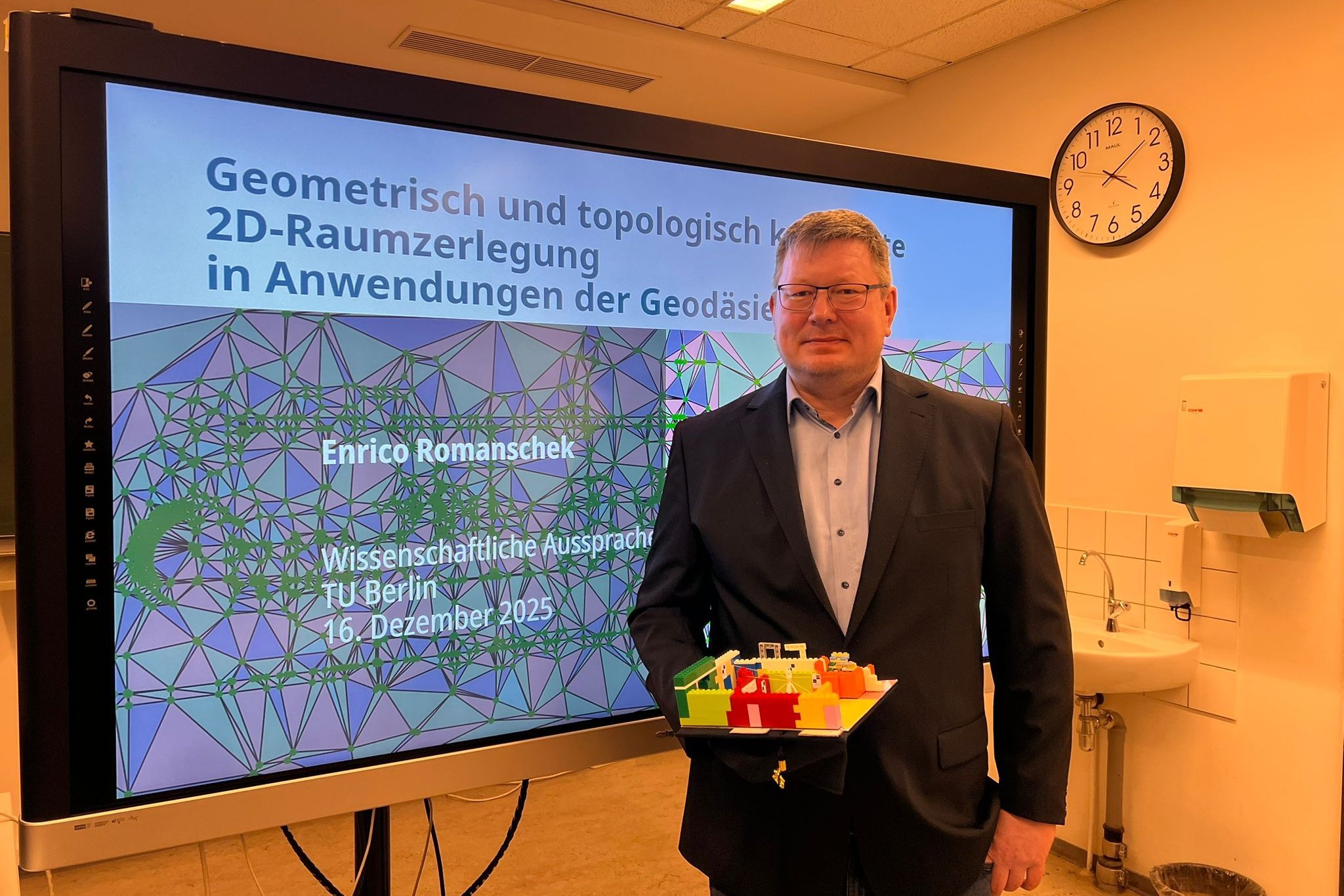 Dr. Enrico Romanschek nach erfolgreicher Promotion mit Doktorhut