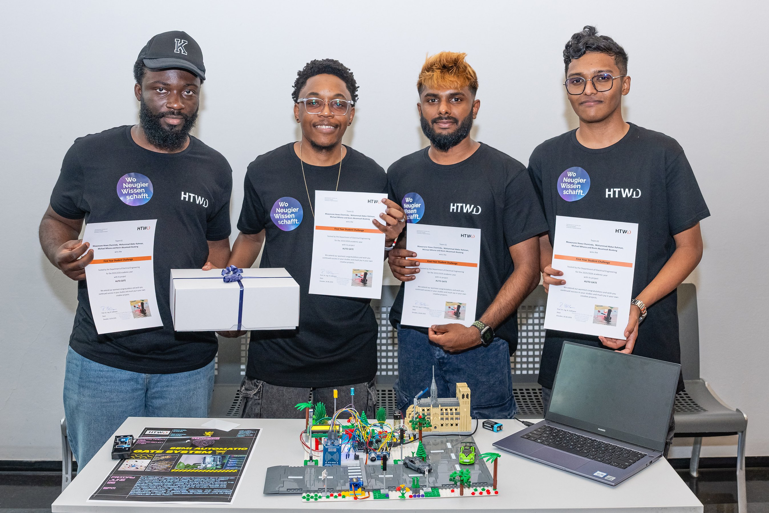 Four young men are holding a certificate